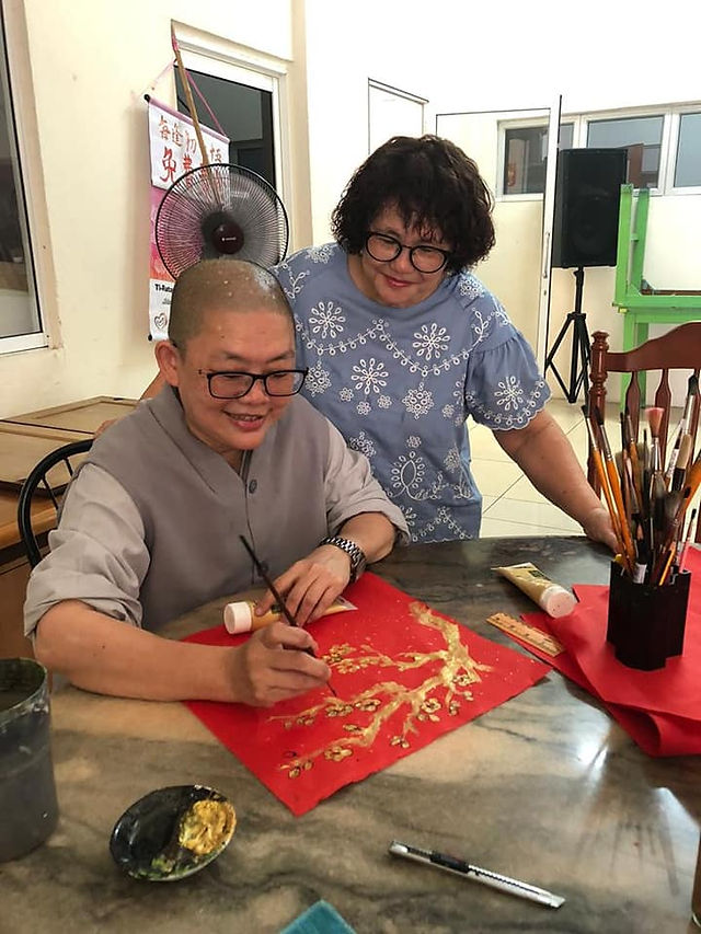 Ti-Ratana Cheras Resident Nun Venerable Shi Fa Zhi in CNY 2022. Market Calligraphy as Dana for the Temple. Photo by Sis Jackie.