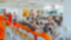 Close-up view of a monk receiving robes during a ceremony